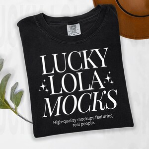 May include: Black t-shirt with white text that reads "Lucky Lola Mock's" and "High-quality mockups featuring real people."
