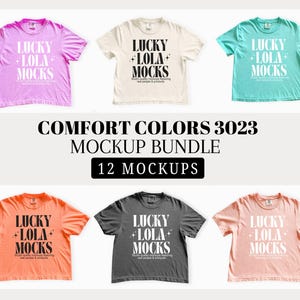 Puede incluir: Un paquete de maquetas con seis camisetas de varios colores: rosa, crema, verde azulado, naranja, carbón y melocotón. Cada camiseta muestra el texto "LUCKY LOLA MOCKS" en blanco. La imagen también incluye el texto "COMFORT COLORS 3023 MOCKUP BUNDLE 12 MOCKUPS."