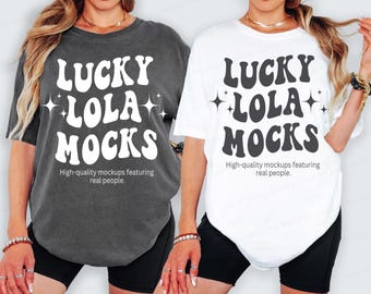 May include: Two t-shirts, one charcoal gray and one white, each with the text "LUCKY LOLA MOCKS" in large, retro-style lettering. Below the text is the phrase "High-quality mockups featuring real people."