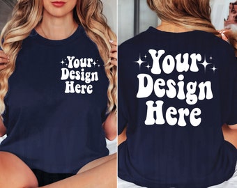 May include: A navy blue t-shirt with white text that says "Your Design Here" on the front and back. The text is in a retro font style with stars on either side.
