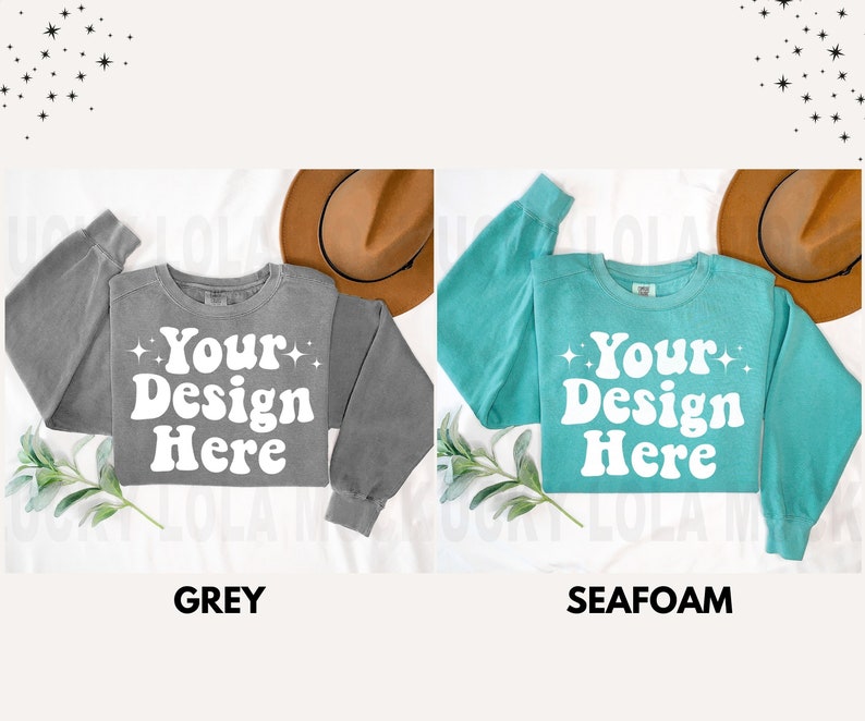 May include: Two sweatshirts, one grey and one teal, with the text "Your Design Here" in a retro font. Both sweatshirts have a relaxed fit and long sleeves.