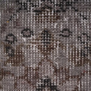 May include: Close-up of a textured fabric with a repeating pattern of small white, brown, and black dots. The fabric has a subtle sheen and a slightly rough texture.