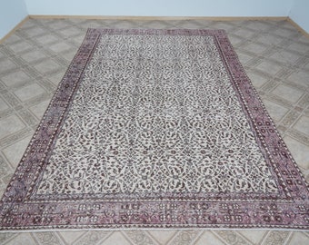 May include: A vintage floral patterned rug with a cream background and a burgundy border. The rug has a traditional design with intricate details.