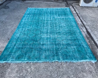 May include: A teal blue vintage rug with a distressed look and fringed edges.