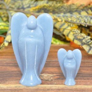 May include: Two blue angel figurines carved from polished stone. The larger angel is about 4 inches tall and the smaller angel is about 2 inches tall.