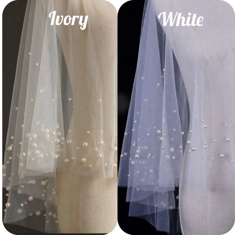 May include: Two bridal veils with pearl embellishments. The veil on the left is ivory and the veil on the right is white.