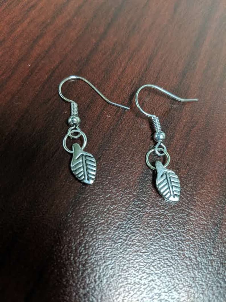 Bracelet and Earring set Necklace and Bracelet have a Silver medallion with leaf accent earring has leaves Silver Tree and leaf Necklace