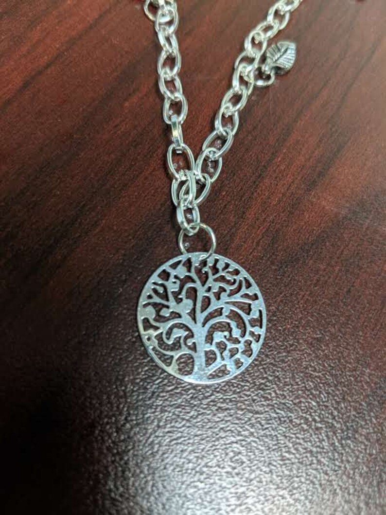 Bracelet and Earring set Necklace and Bracelet have a Silver medallion with leaf accent earring has leaves Silver Tree and leaf Necklace