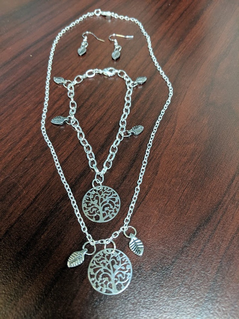 Bracelet and Earring set Necklace and Bracelet have a Silver medallion with leaf accent earring has leaves Silver Tree and leaf Necklace