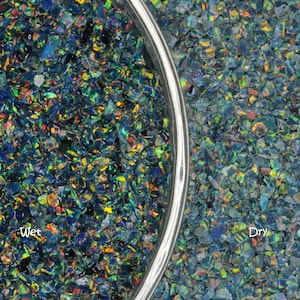 May include: A close-up image of iridescent black opal chips, some wet and some dry. The wet chips are in a clear glass bowl, while the dry chips are on a flat surface. The text "Wet" and "Dry" is visible below the chips.