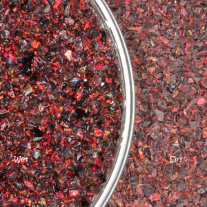May include: Close-up of red and black crushed glass, with a metallic bowl rim on the left. The text "Wet" is visible on the left side, and "Dry" on the right, showing the difference in appearance.