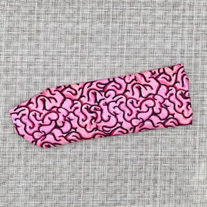 Headband with pink/black brain print.