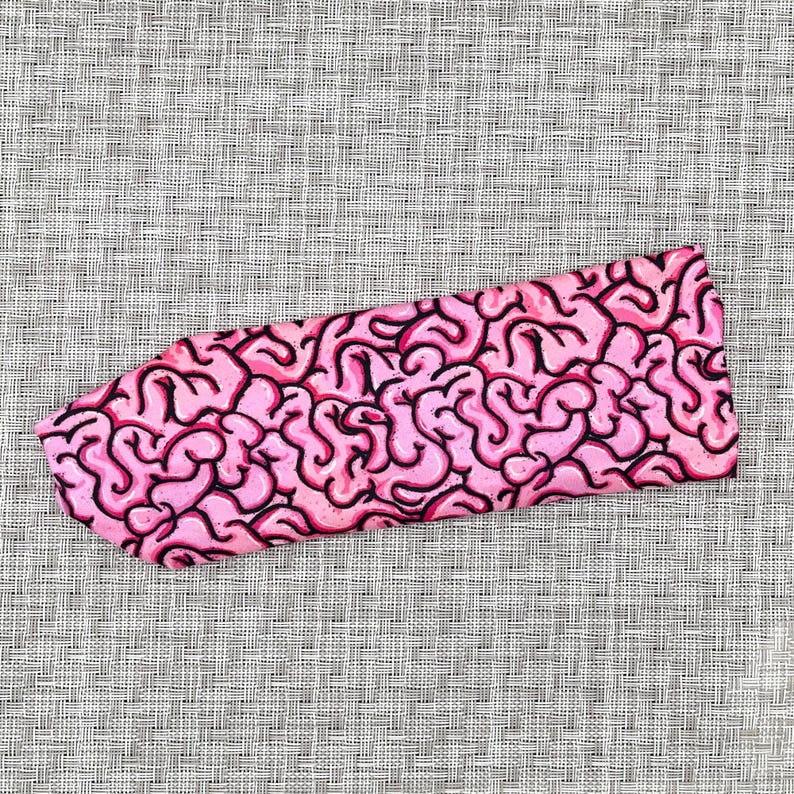 Headband with pink/black brain print.