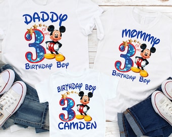 May include: White t-shirts with a Mickey Mouse design and the text "Daddy of the 3 Birthday Boy", "Mommy of the 3 Birthday Boy", and "Birthday Boy Camden".