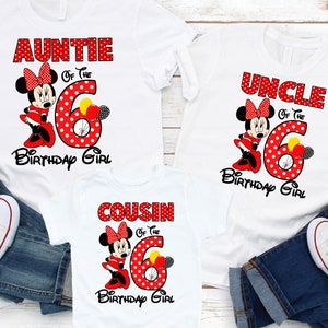 May include: Three white t-shirts with red polka dot Minnie Mouse designs. The shirts say "Auntie of the Birthday Girl", "Uncle of the Birthday Girl", and "Cousin of the Birthday Girl".
