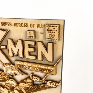 May include: A wooden cutout of a vintage comic book cover featuring the X-Men. The cover is brown and features the text "SUPER-HEROES OF ALL!" and "X-MEN". The cover also includes the text "DON'T MISS THIS FABULOUS FIRST ISSUE!" and a seal that reads "APPROVED BY THE COMICS CODE AUTHORITY".