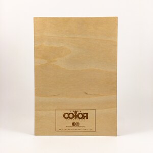 May include: A wooden sign with the text "Four Color Creations" and a logo of four coloured squares. The sign also includes the text "#fourcolorcreations" and "www.fourcolorcreations.com".