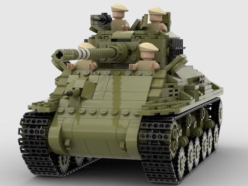 May include: A green toy tank with black tracks and four toy soldiers in the turret. The tank has a large cannon and a smaller machine gun.