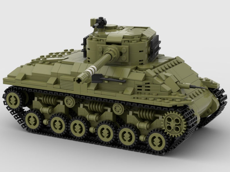 May include: A green Lego model of a tank with a black gun barrel and black tracks.