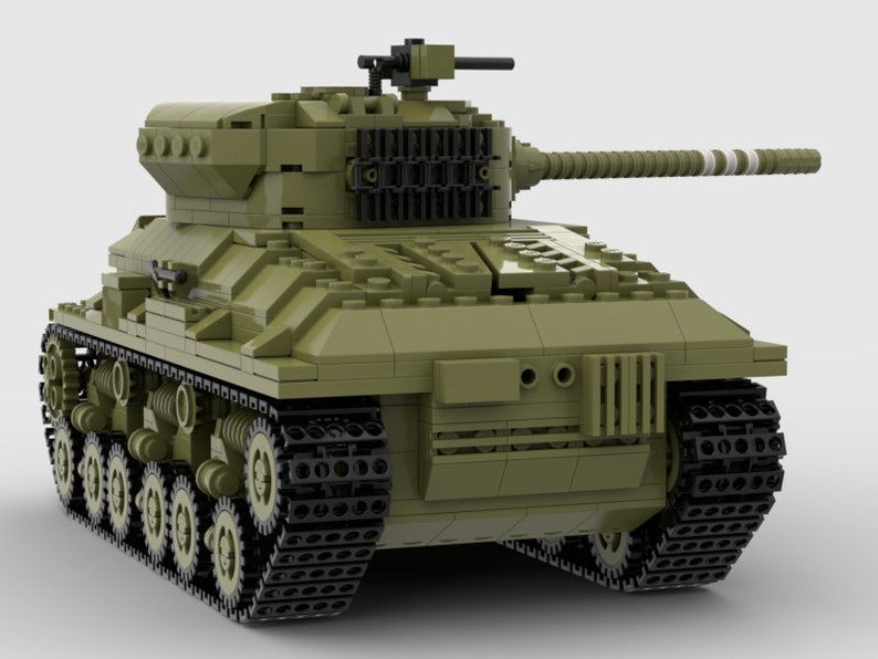 May include: A green toy tank with black tracks and a white stripe on the barrel of the gun.