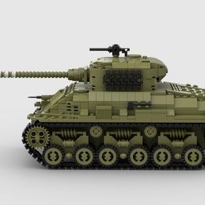 May include: A green toy tank with a black gun barrel and black wheels. The tank has a detailed design with a textured surface.