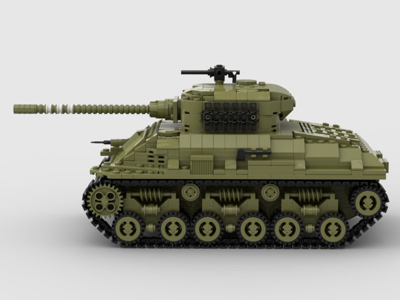 May include: A green toy tank with a black gun barrel and black wheels. The tank has a detailed design with a textured surface.