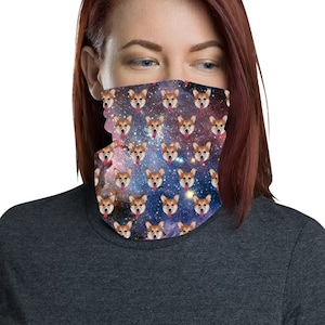 May include: A woman wearing a face covering with a repeating pattern of a dog's face on a galaxy background.