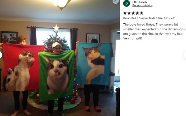 May include: Three fleece blankets, each featuring a large cat portrait. The blankets are held up by people, showcasing the cat images against red, green, and blue backgrounds. Each blanket measures 30" x 40".