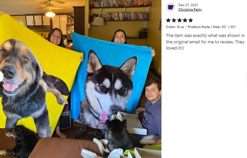 May include: Three people hold up large, personalized dog blankets. One is yellow, and the other is blue, each featuring a close-up of a dog's face. The blankets measure 50 x 60 inches.