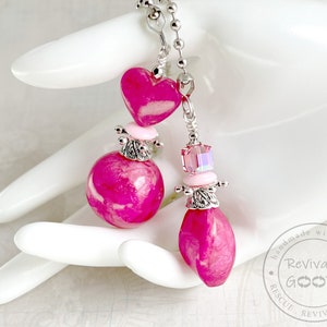 May include: Pink and silver heart and teardrop shaped pendant light pull with a crystal bead. Handmade with heart. Revivable Goods. Rescue. Revive. Reuse.