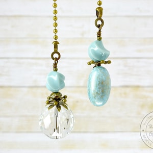 May include: Two light blue and gold ceiling fan pull chains with crystal and ceramic beads. Handmade with heart, Revivable Goods, Rescue, Revive, Reuse.