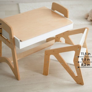 May include: A wooden children's desk and chair set with a white drawer. The desk measures 19.6 inches tall and the chair measures 11.8 inches tall.