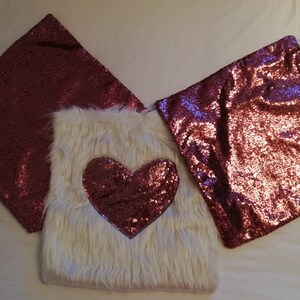 A set of plush cushion covers designed by a shiny sequin heart and two shiny sequin cushion covers.  Pillow Covers.  Love. Gift. Heart.