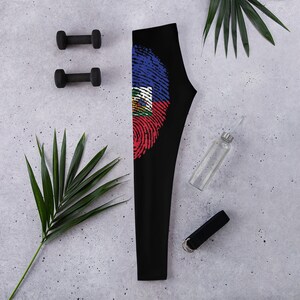 May include: Black leggings with a fingerprint design featuring the Haitian flag colours of blue, red and white.