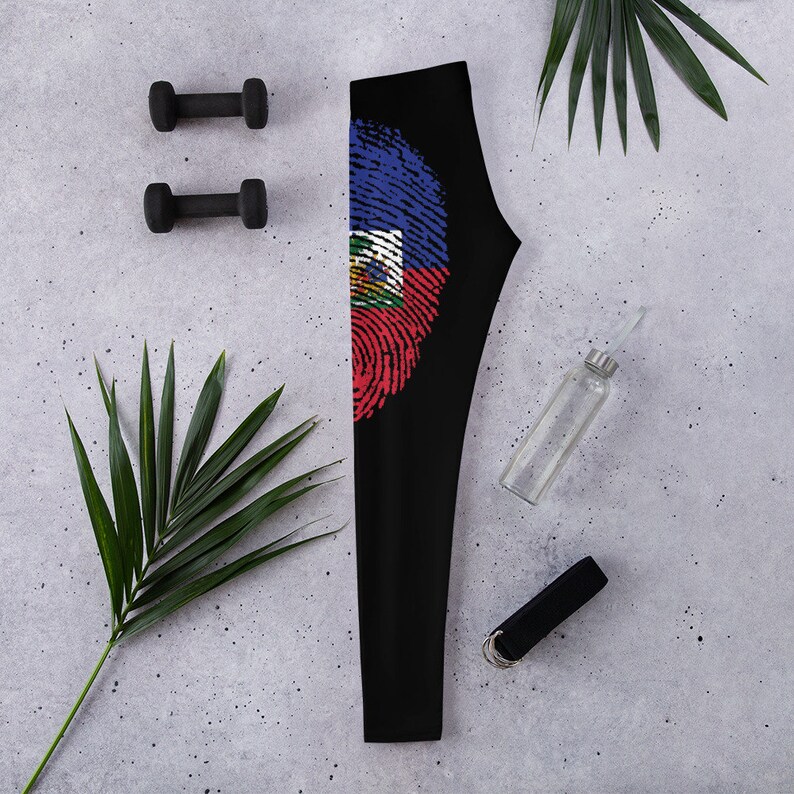 May include: Black leggings with a fingerprint design featuring the Haitian flag colours of blue, red and white.
