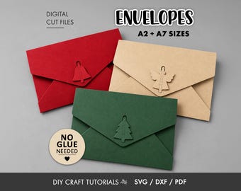 May include: Three paper envelopes in red, tan, and dark green, each featuring a die-cut holiday shape: a bell, an angel, and a tree. Text reads: ENVELOPES A2 + A7 SIZES, DIGITAL CUT FILES, NO GLUE NEEDED, and DIY CRAFT TUTORIALS SVG / DXF / PDF.