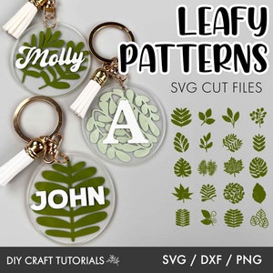 May include: A set of 24 leafy SVG cut files for crafting. The image shows two keychains with the names "Molly" and "John" on them, with a leafy design. The image also shows a variety of leaf patterns, including simple leaves, fern leaves, and monstera leaves.