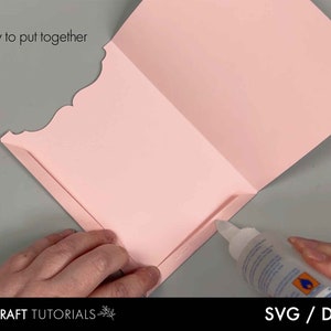 May include: A light pink paper craft project is being assembled with glue. The text "Easy to put together" is visible. The bottom of the image shows the text "DIY CRAFT TUTORIALS" and "SVG / DXF".