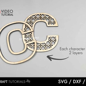 May include: Two-layer wooden letters 'G' and 'C' with a decorative lattice pattern. The 'G' is a solid outline, while the 'C' has a detailed design. The image includes the text 'VIDEO TUTORIAL' and 'Each character has 2 layers'. The bottom text reads 'DIY CRAFT TUTORIALS' and 'SVG / DXF / AI'.