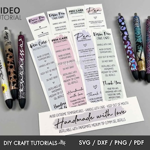 May include: A collection of handmade resin pens with glitter and decorative designs, including a sunflower, leopard print, and tropical scene. Accompanying care instruction cards and a "Handmade with love" card are also visible.