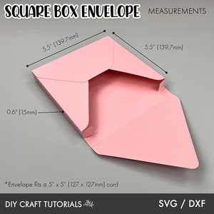 May include: A pink square box envelope with measurements in inches and millimeters. The envelope is designed to fit a 5 inch by 5 inch card. The text "SQUARE BOX ENVELOPE MEASUREMENTS" is at the top of the image. The text "DIY CRAFT TUTORIALS" is at the bottom of the image. The text "SVG / DXF" is at the bottom right of the image.