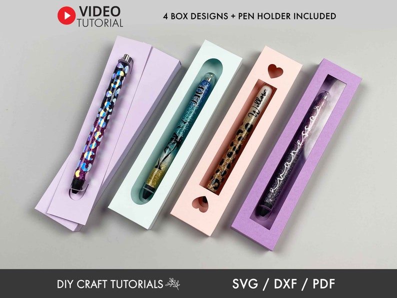 May include: Four different pen holder box designs with a window to display the pen. The boxes are in purple, pink, blue, and light purple. The text "4 BOX DESIGNS + PEN HOLDER INCLUDED" is at the top of the image. The text "DIY CRAFT TUTORIALS" is at the bottom left of the image. The text "SVG / DXF / PDF" is at the bottom right of the image.