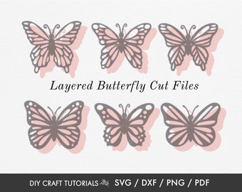 May include: Six gray butterfly cut files with pink shadows are displayed on a white background. The text "Layered Butterfly Cut Files" is above the butterflies. Below the butterflies is the text "DIY CRAFT TUTORIALS SVG / DXF / PNG / PDF".