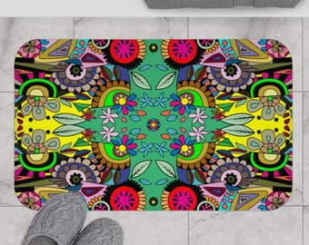 May include: A colorful bath mat with a geometric and floral design. The mat features a green background with yellow, red, blue, pink, and black accents.