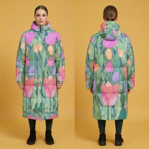 May include: A long, quilted puffer coat featuring a vibrant floral pattern of pink, orange, and purple tulips on a green background. The coat includes a hood, long sleeves, and a front zip closure, shown from both the front and back views.