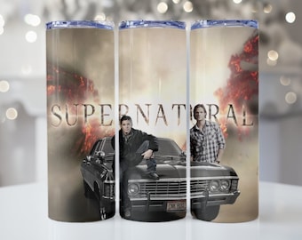 May include: A stainless steel tumbler with a black and white image of two men standing in front of a black car. The car has a license plate that reads "CNK 8003". The background is a blurry image of a fiery explosion. The text "SUPERNATURAL" is printed in white on the tumbler.