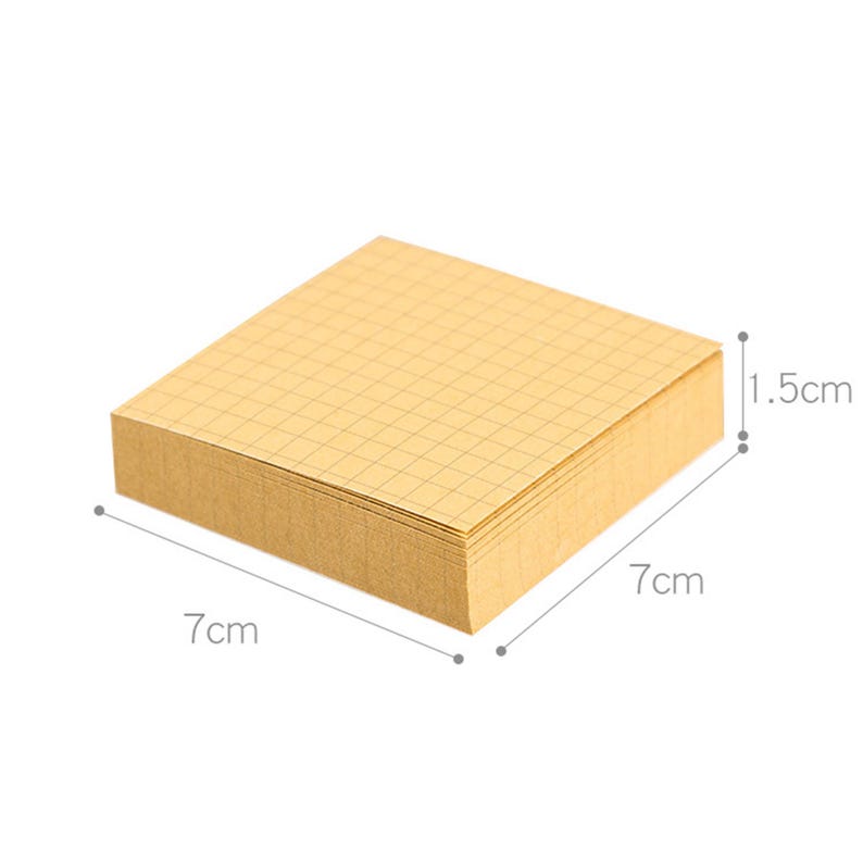 May include: A stack of 7cm by 7cm square sticky notes with a grid pattern. The notes are 1.5cm thick.