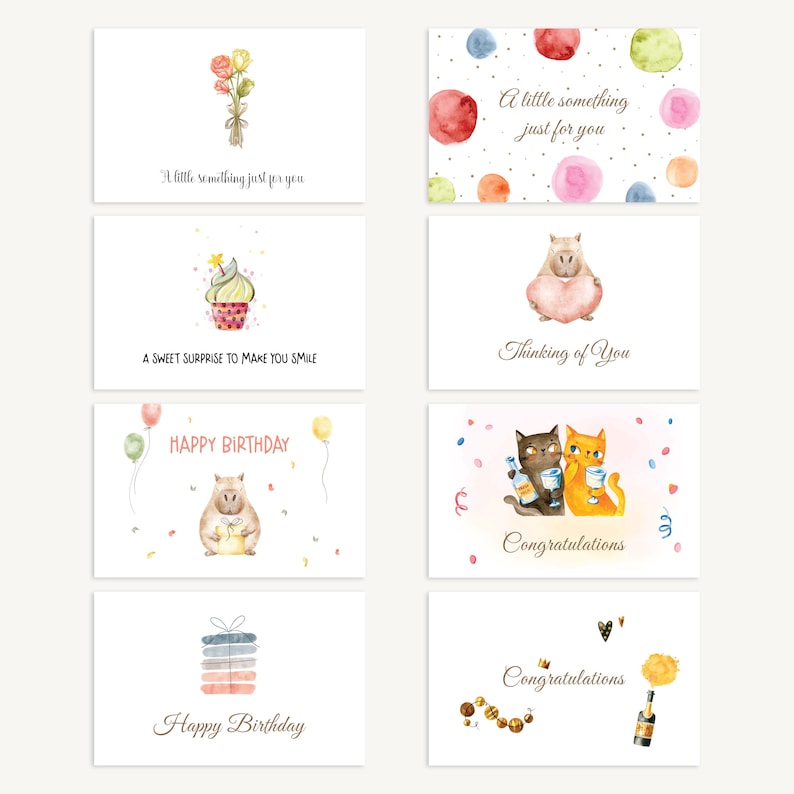 May include: A collection of eight greeting cards with watercolor illustrations. Designs include a bouquet of flowers, a cupcake, a capybara holding a heart, two cats toasting, and gift boxes. Each card has a different message.