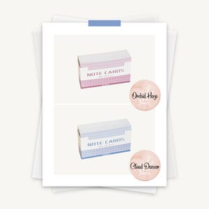 May include: Two boxes of note cards, one pink and one blue, with the text "NOTE CARDS" on the front. The pink box has a sticker that says "Orchid Haze" and the blue box has a sticker that says "Cloud Dancer".