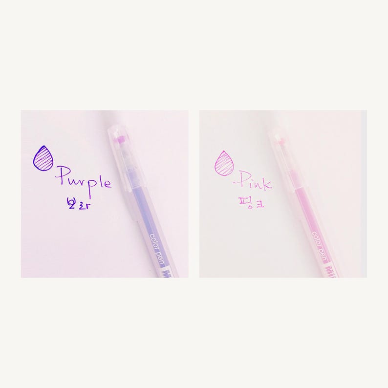 May include: Two clear gel pens with purple and pink ink. The pens have a clear barrel and a silver cap. The ink color is shown next to each pen with a drop of ink and the word "Purple" or "Pink" written in the corresponding ink color.